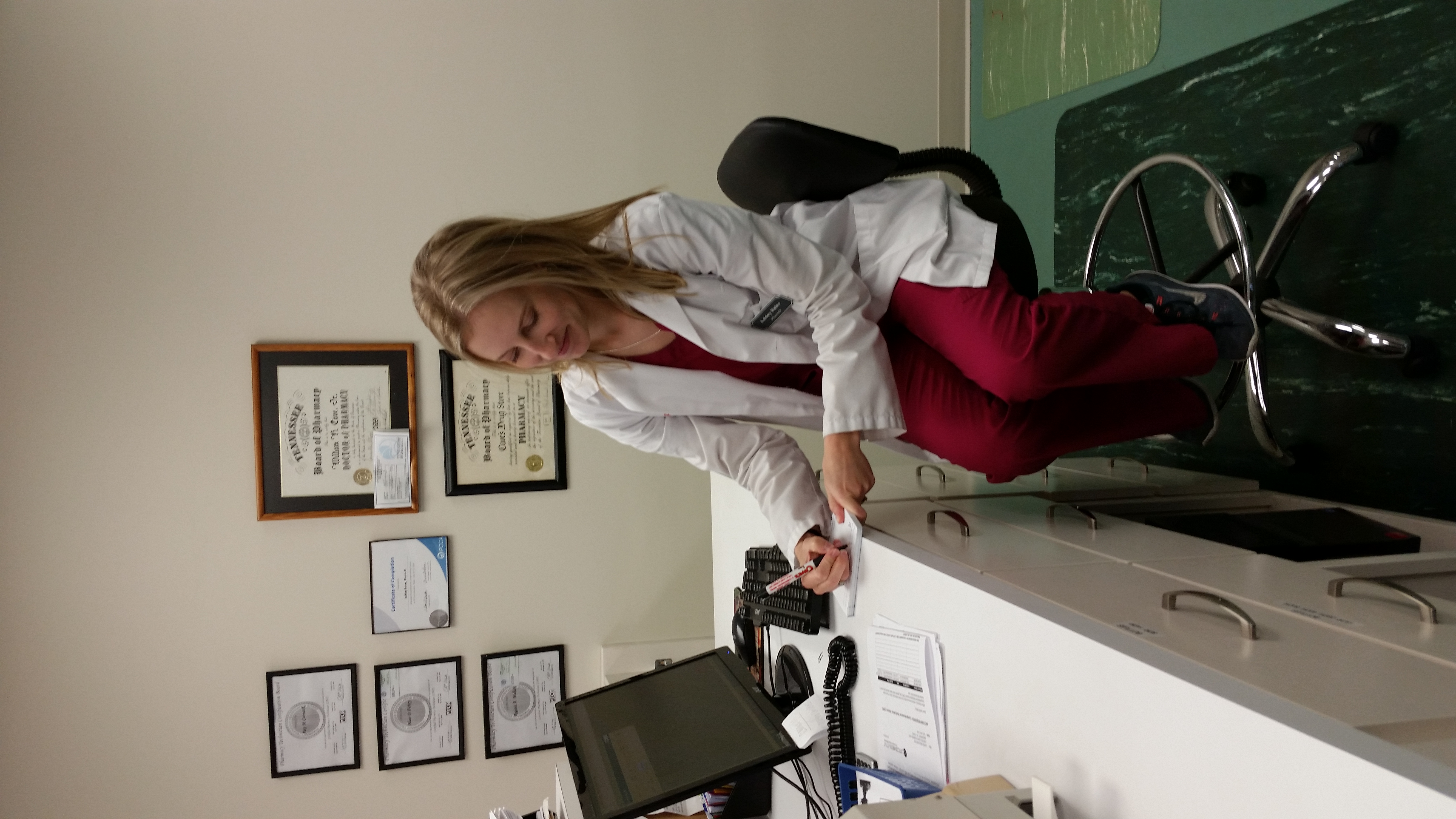 Ashley Bates working at the pharmacy counter
